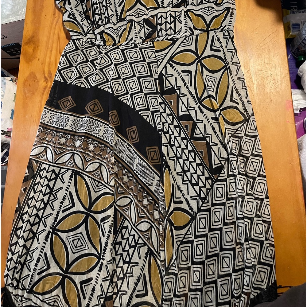 I’m selling a gray black and brown dress missing buttons at the top